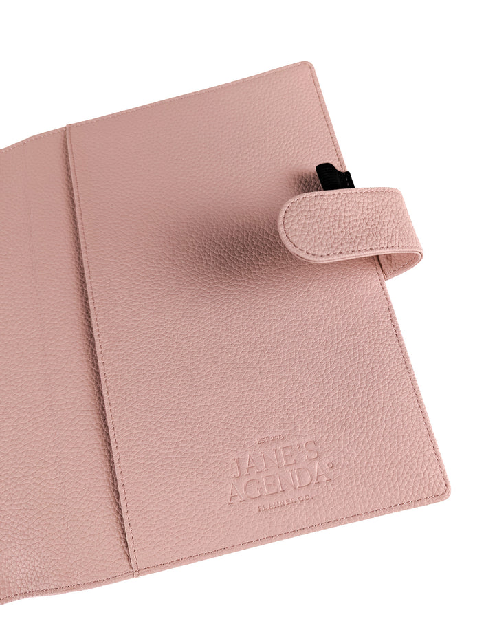 Blush pink vegan leather wrap around discbound planner cover by Jane's Agenda.