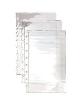 Set of three clear plastic discbound planner sleeves on a white background