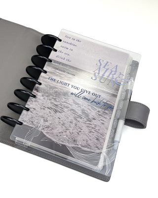 Planner with a clear cover featuring oceanic designs and text on a white background