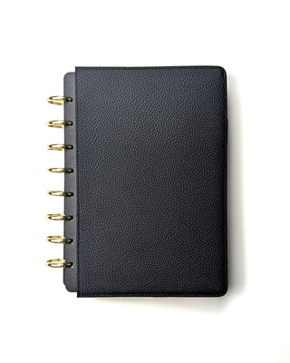 Closed black snap planner cover from Jane's Agenda with a gold disc-binding system