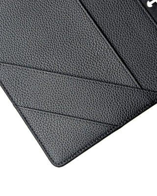 Close-up of angled pocket stitching inside the black planner cover, showing textured vegan leather details.