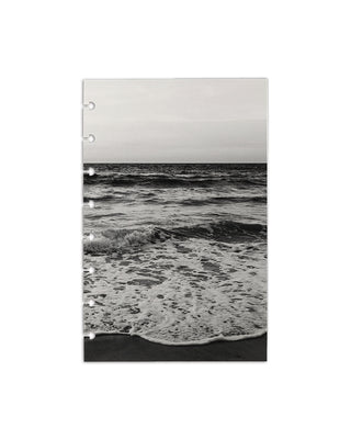 Monochrome beach and ocean waves scene evoking serene shoreline and travel‑inspired coastal scenery, on a white background.