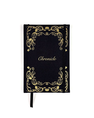 A Black and gold journal with the word Chronicle on the front