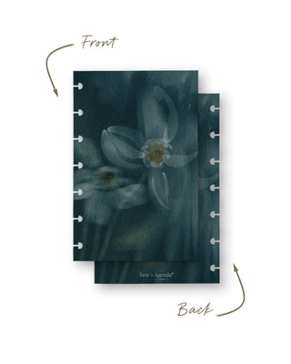 Front and back views of a removable discbound planner dashboard featuring a soft-focus watercolor floral design with large white blossoms on a deep teal background. Both sides display coordinating artwork for a dreamy, elegant botanical aesthetic.