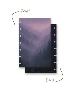 Front and back views of a Jane’s Agenda discbound planner dashboard featuring a moody, mist-covered evergreen forest in soft purple, lavender, and deep blue tones.