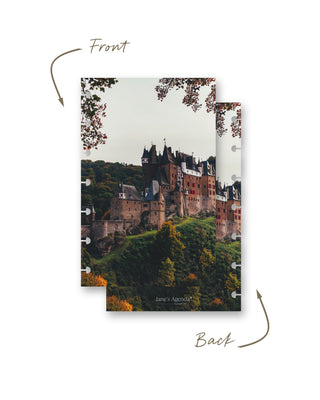 Front and back views of a Jane’s Agenda discbound planner dashboard featuring a grand historic castle surrounded by lush hills and autumn foliage.