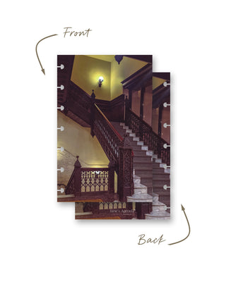 Front and back views of a Jane’s Agenda discbound planner dashboard featuring a grand vintage staircase with dark ornate wood railings, marble steps, and warm ambient lighting.
