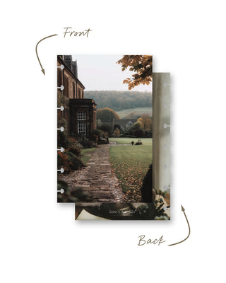 Double-sided discbound planner dashboard shown front and back. The front features a stately country home and stone garden path surrounded by an autumn landscape, while the back features a cozy neutral-toned interior scene.