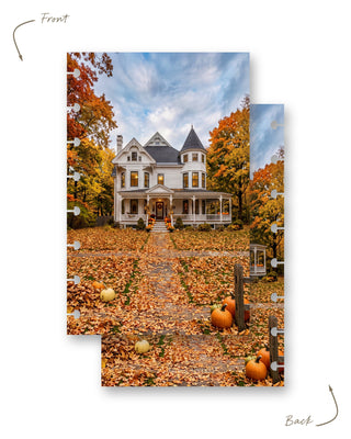 Jane’s Agenda reversible autumn-themed discbound planner dashboard featuring a charming white Victorian house surrounded by vibrant orange and golden fall trees. A leaf-covered walkway lined with pumpkins leads to the welcoming front porch. Both sides feature the same cozy autumn scene, with disc-punched edges for easy planner customization.