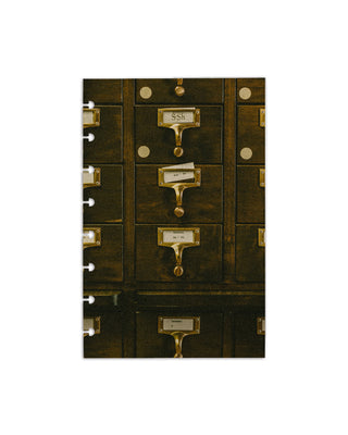 A cardstock planner dashboard with an image of a library card catalog with brass handles on a white background for discbound planner sytems.