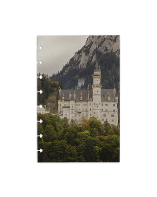 Notebook with a castle and mountain design on the cover