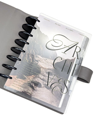A planner featuring the Coastal Cove dashboard layered with the Archives planner cover on a white background. 