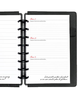 Open planner with two pages showing goal-setting templates on a white background