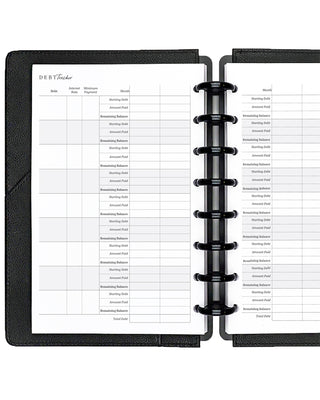 Open discbound planner with black cover and white insert pages on a white background