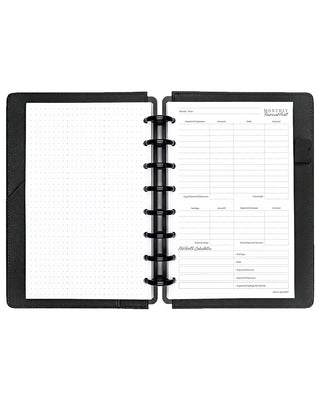 Open discbound planner with black cover and white insert pages on a white background