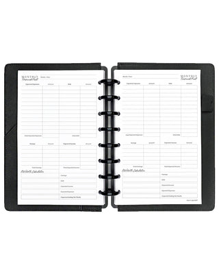 Open discbound planner with black cover and monthly financial audit insert pages on a white background