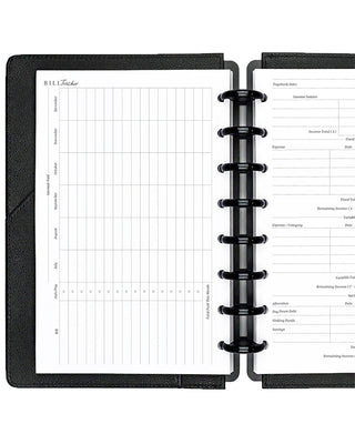 Open discbound planner with black cover and bill tracker insert pages on a white background