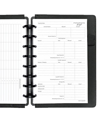 Open discbound planner with black cover and paycheck budget insert pages on a white background