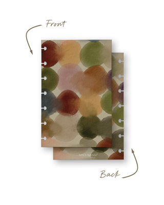 Front and back view of a removable discbound planner dashboard featuring an abstract watercolor design with overlapping circles in earthy shades of rust, olive green, blush pink, mustard, blue, and taupe. The coordinating back continues the same painterly pattern with subtle Jane’s Agenda branding.