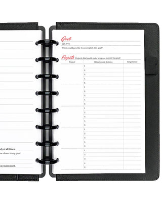 Black planner with a page open showing goal setting and project tracking sections.