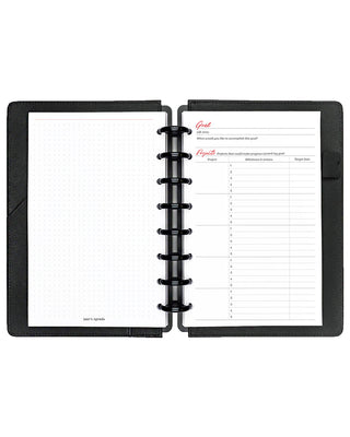 Open planner with two pages showing goal-setting templates on a white background