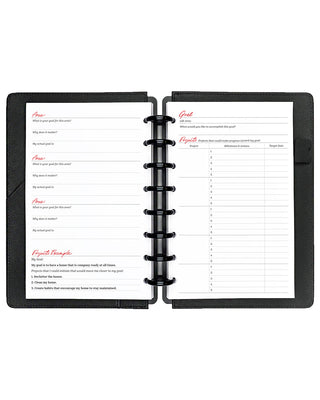 Open planner with two pages showing goal-setting templates on a white background