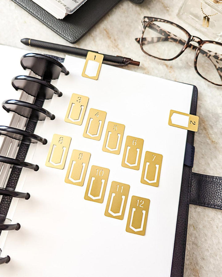 Gold metal page clips set that is numbered one through twelve  by Jane's Agenda.