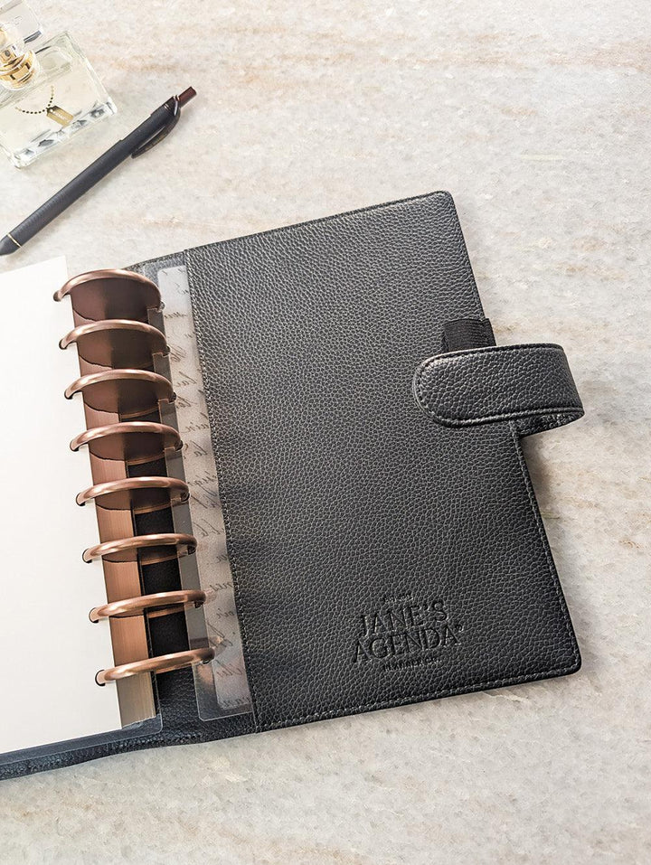 Vegan leather discbound planner cover in a unique shade of gray that is used for discbound planners by Jane's Agenda. 