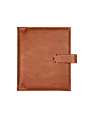 Front view of a warm brown leather planner cover displayed against a clean white background. The cover features a smooth leather exterior with natural grain, rounded corners, and a matching leather snap closure, creating a c