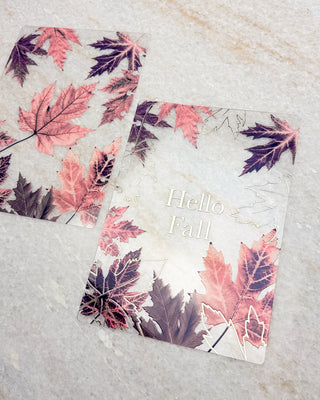 Clear discbound planner cover and matching dashboard featuring layered autumn maple leaves in pink, burgundy, and purple tones, with “Hello Fall” in gold lettering.
