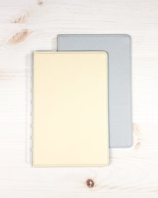 Discbound vegan leather snap on cover that is reversible, showing both sides overlapping on a white background.