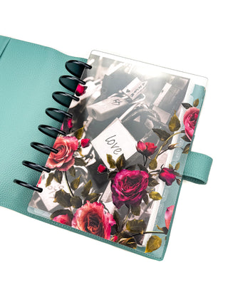 Victorian-inspired, vibrant color roses, clear planner cover, layered with the Romantic Locks planner dashboard. With Onyx metal discs and the Sea Glass Teal Vegan Leather Wrap Cover. 