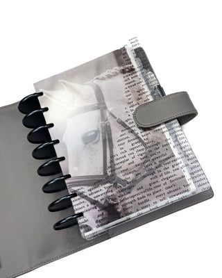 The grey leather cover featuring a planner with a white horse dashboard and the literary art clear cover. 