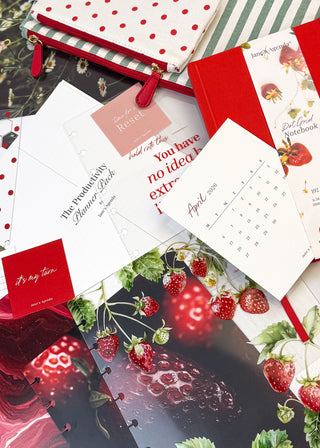 Collage of stationery items including a red polka dot pouch, cards, and a calendar with a strawberry design by Janes Agenda for discbound planners and disc notebooks.
