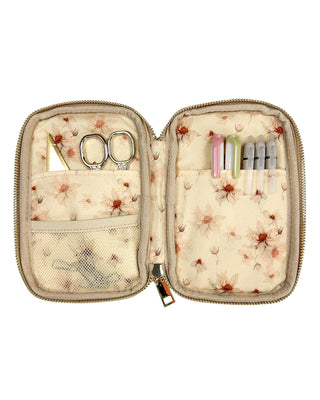 Floral-patterned sewing kit with scissors and tools on a white background