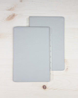 Discbound vegan leather snap on cover that is reversible, showing the back of the cover overlapping on a white background.