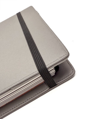 Gray planner with a black strap on a white background