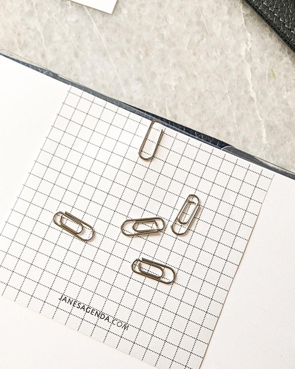Silver metal mini paperclips for clipping notes and quote cards to your discbound or six ring planner, notebook, or binder by Jane's Agenda.