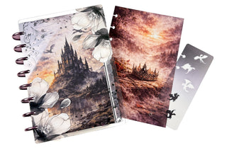Notebook with artistic cover design and additional cards on a white background