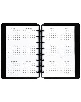 Open planner showing a yearly calendar layout on two pages.