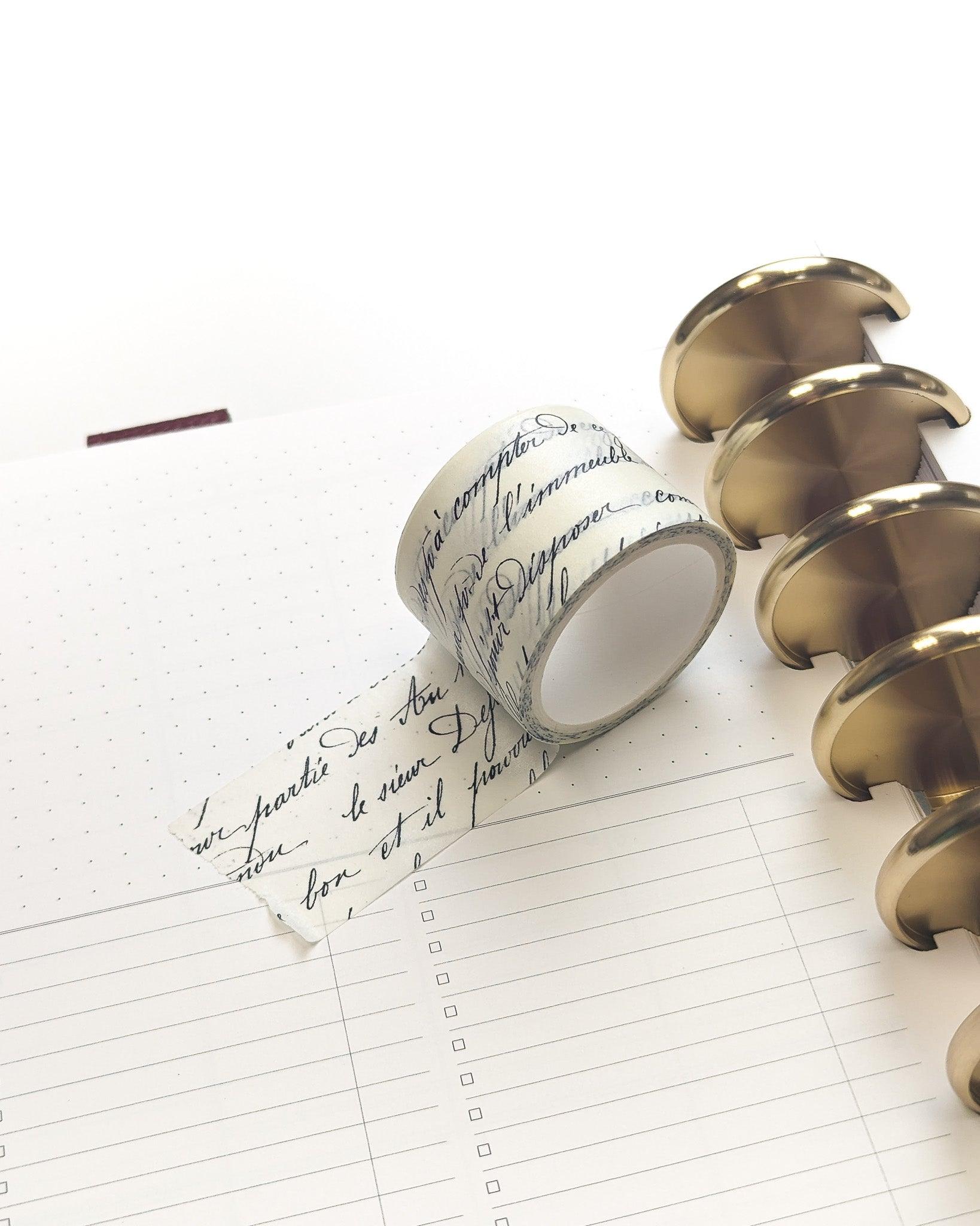 White washi tape with French cursive handwriting in black ink by Jane's Agenda.