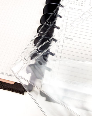 Clear discbound planner pocket sleeves over a discbound planner.