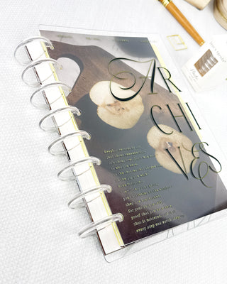 Planner with clear plastic discbound binding on a white surface
