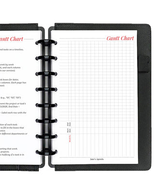 Project planner inserts inside a black discbound planner notebook over a white background.