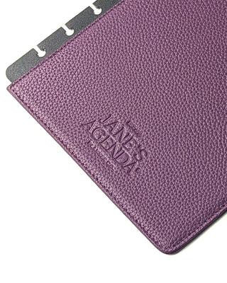 Detailed view of Jane’s Agenda logo embossed on the back interior of the purple snap planner cover.