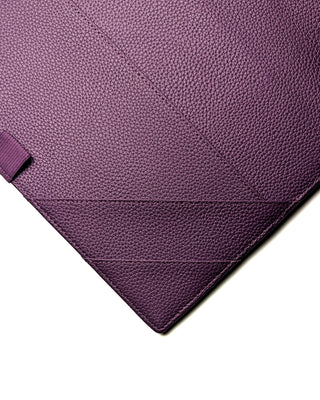 Detail of the angled pockets and stitching on the inside front cover of a purple leather planner wrap from Jane's Agenda, showing texture and craftsmanship.