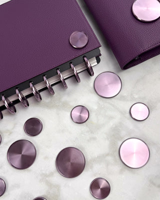 Lavender metal discs with a purple leather discbound planner.