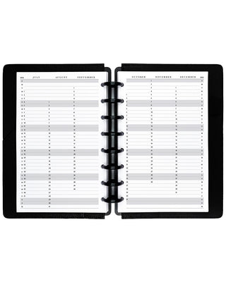 Open planner with monthly schedule on each page, black disc binder on white background