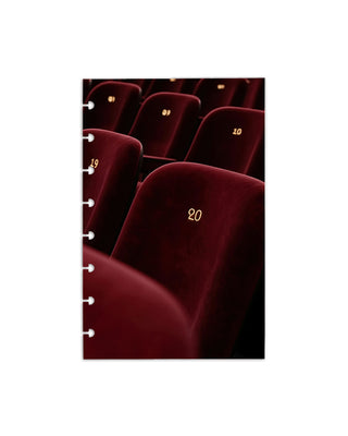 A discbound planner dashboard of red velvet theater seats with numbers on a white background