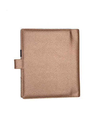 Rose gold vegan leather planner cover for discbound panners over a white background.